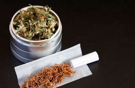 Marijuana on Grinder, with Cigar, Dark Backgroundの写真素材