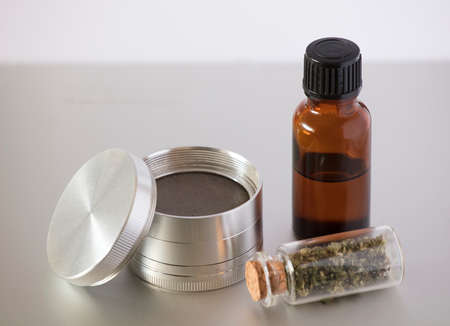 Grinder with glass jar with marijuana oil and airtight transparent containerの写真素材
