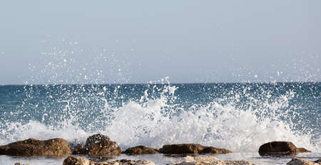 Waves splashed over rocks on a very windy day
