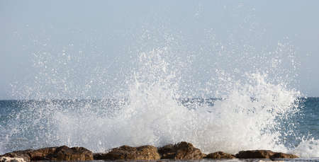 Beautiful waves crashing on the rocks of the bayの写真素材