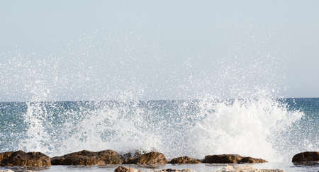 Beautiful waves crashing on the rocks of the bayの写真素材