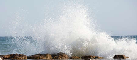 Beautiful waves crashing on the rocks of the bayの写真素材