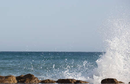 Beautiful waves crashing on the rocks of the bayの写真素材