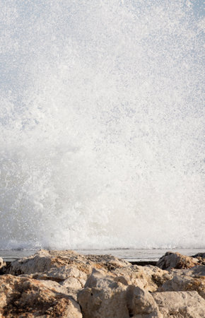 Big waves crash onto the shore with marine foamの写真素材