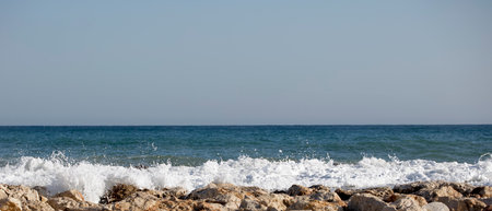 Beautiful waves crashing on the rocks of the bayの写真素材