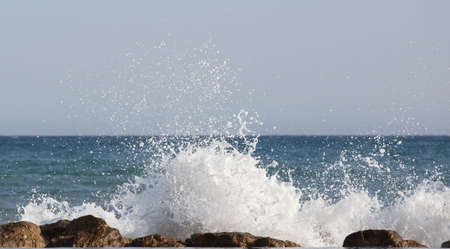 Beautiful waves crashing on the rocks of the bayの写真素材
