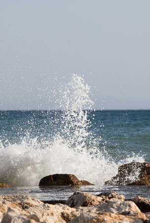 Beautiful waves crashing on the rocks of the bayの写真素材