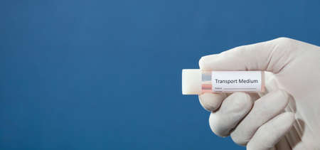 transport vial for laboratory, with sticker personal data in the hands of doctor, with blue backgroundの写真素材