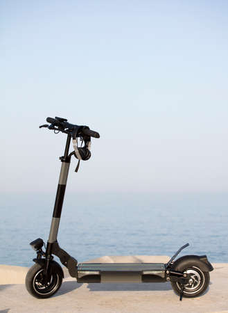 electric scooter, with sea in the background.の写真素材