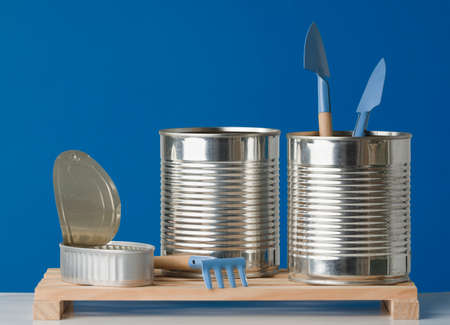 Group of recycled cans. three recycled cans on wooden boards blue background.の写真素材