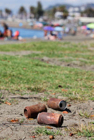 Travelers or tourists dropped cans, very rusty like polluted trash on the beach long ago. Tin can damage and rust.の写真素材