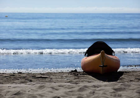 kayak on the sand with sea in the background, sunny dayの写真素材