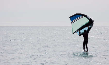 sportsman with wing foil sailing, in the seaの写真素材