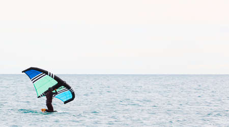 sportsman with wing foil sailing, in the seaの写真素材