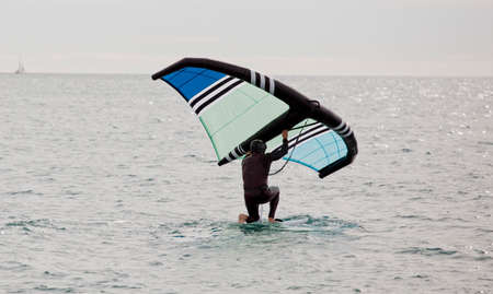 sportsman with wing foil sailing, in the seaの写真素材