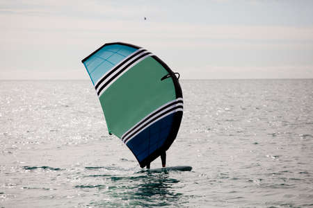 sportsman with wing foil sailing, in the seaの写真素材