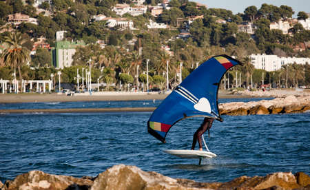 Wing Foiling is practiced on a short but wide and thick stand up paddle board to allow your rider to stay stable and stand easily on the board.の写真素材