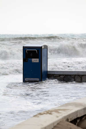 garbage cans thrown on the beach, strong tides, climate change,の写真素材