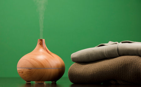 Scent sink, essential oils with clothing, light green surface with reflection. Green background.の写真素材