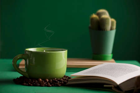 cup of tea or coffee, green color, hot with steam, open book, cactus, with table and green.の写真素材