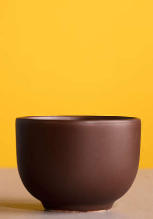 brown cup with coffee or chocolate, with yellow backgroundの写真素材