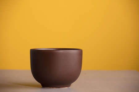 brown cup with coffee or chocolate, with yellow backgroundの写真素材