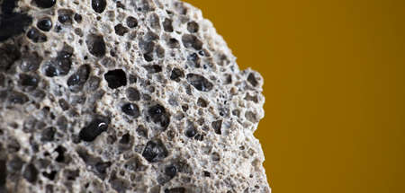 Meteorite rock detail, with light brown background.の写真素材