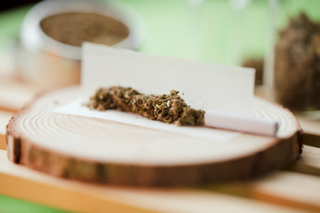 chopped marijuana, on cigarette paper with filter and airtight glass jar storage, process to make marijuana cigar.の写真素材