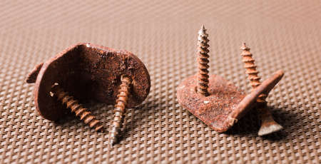 metal angle brackets with corrosive rust and deteriorate screws.の写真素材
