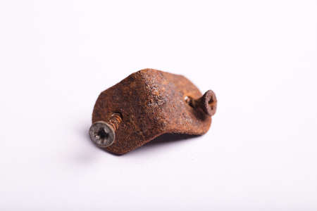 metal angle bracket with corrosive rust and deteriorated screws, white backgroundの写真素材
