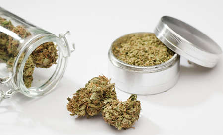 Close up of medical marijuana buds , crusher , glass bottles, white backgroundの写真素材