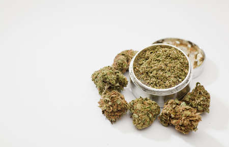 medical marijuana buds and grinder, isolated on white backgroundの写真素材