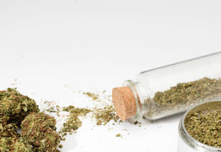 recreational marijuana buds, grinder, glass bottle, isolated on white backgroundの写真素材