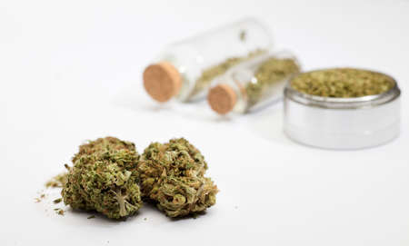 Close-up of medical marijuana buds, aluminum grinder, white backgroundの写真素材