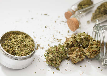 Close-up of medical marijuana buds, aluminum grinder, white backgroundの写真素材