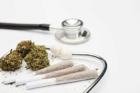 marijuana buds, joint, phonendoscope, with white background, space for text.の写真素材