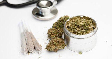 Joint, marijuana buds, grinder with phonendoscope, with white background.の写真素材