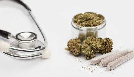 Joint, marijuana buds, grinder with phonendoscope, with white background.の写真素材