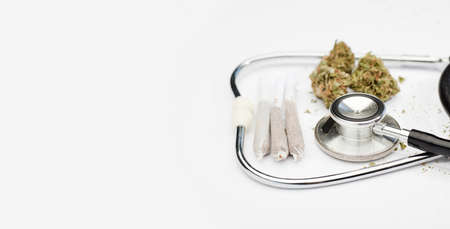marijuana joint with stethoscope on white background, space for text.の写真素材