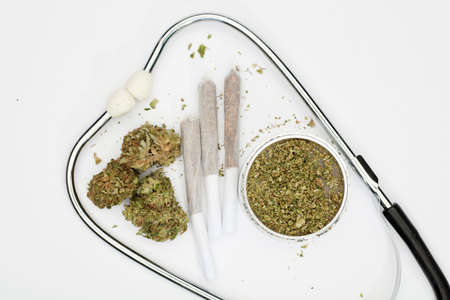 marijuana buds, joint, phonendoscope, grinder with white background, space for text.の写真素材