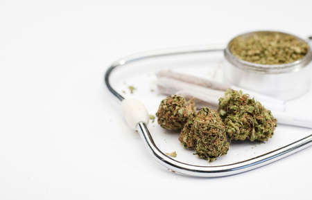 marijuana buds, joint, phonendoscope, grinder with white background, space for text.の写真素材