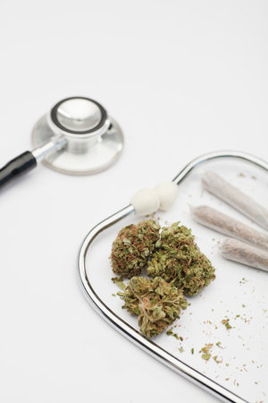 marijuana buds, joint, phonendoscope with white background, space for text.の写真素材