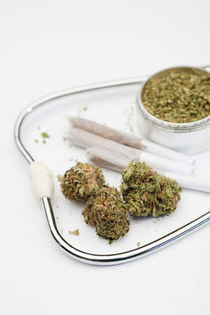 marijuana buds, joint, phonendoscope, grinder with white background, space for text.の写真素材