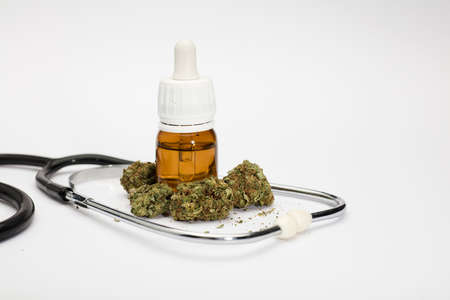set of marijuana buds, with dosing bottle, stethoscope, white background.の写真素材