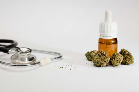 set of marijuana buds, with dosing bottle, stethoscope, white background.の写真素材