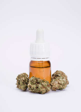 set of marijuana buds, with dispenser bottle, white background.の写真素材