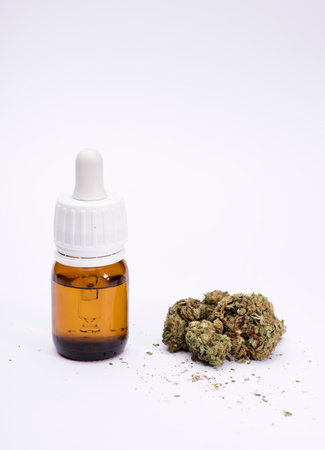set of marijuana buds, with dispenser bottle, white background.の写真素材
