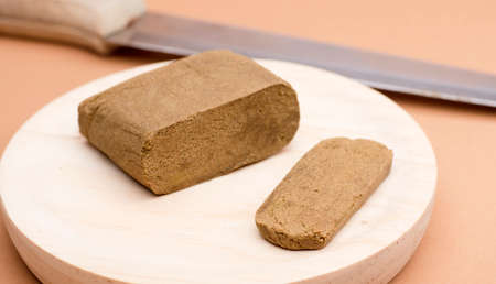 hashish large portion on wood with knife blade, brown backgroundの写真素材