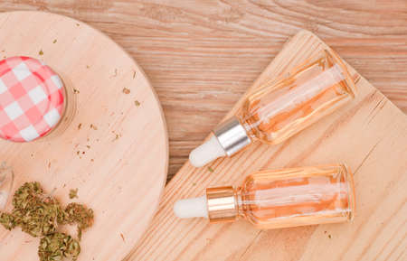 marijuana oil in glass dispenser bottles with budsの写真素材