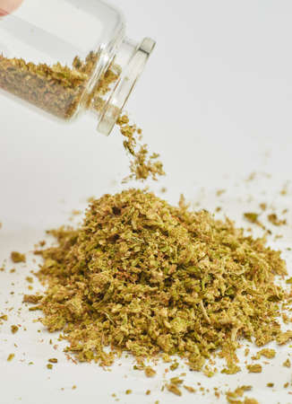 pile of marijuana, glass pot, white background